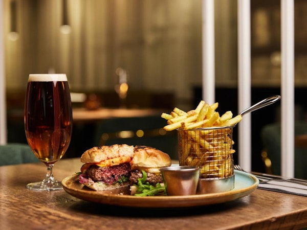A burger, chips, and beer at the Konvin Hotel restaurant in Keflavik.