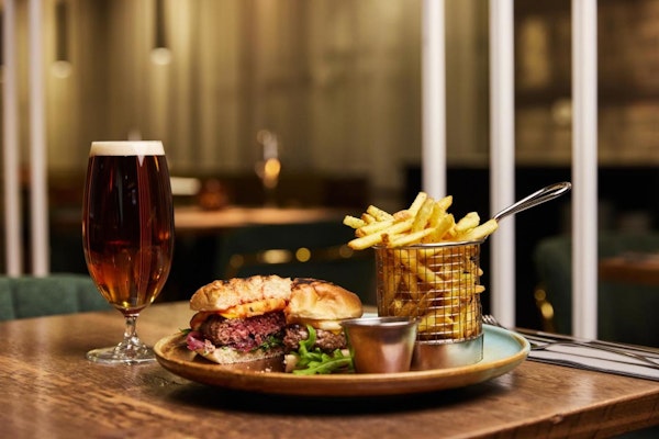 A burger, chips, and beer at the Konvin Hotel restaurant in Keflavik.