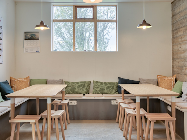 Enjoy complimentary refreshments and engaging conversations in Skyrhusid HI Hostel's inviting common area.