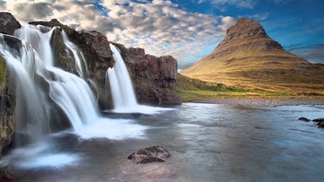 The Kirkjufell mountain with its distinctive cone shape, and the Kirkjufell waterfall in the foreground.