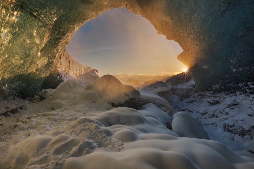 Sun shining during golden hour in an ice cave in Iceland