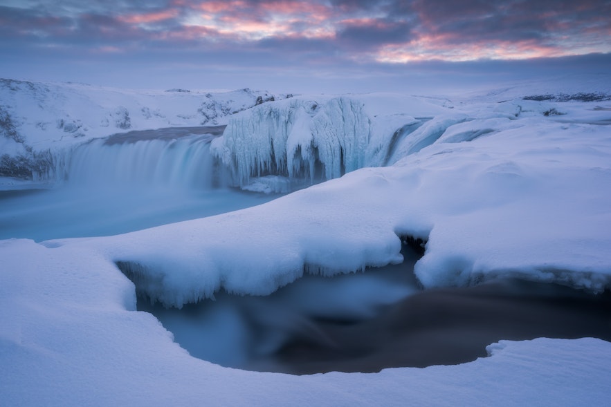 Godafoss in the North of Iceland frozen over in winter