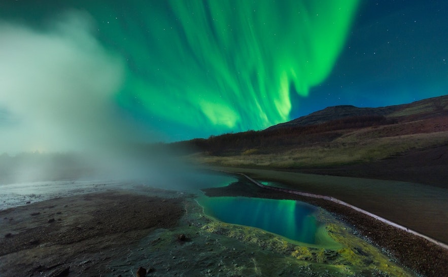 Aurora borealis or northern lights over the Geysir geothermal area