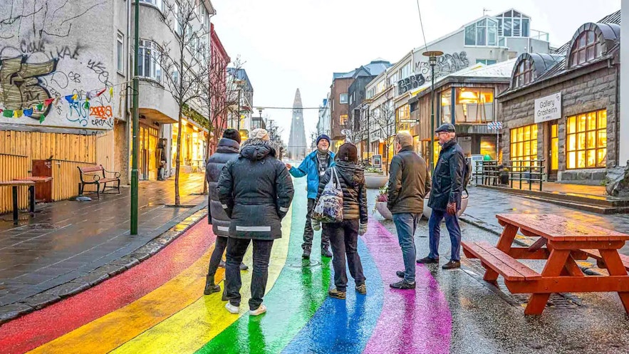 Travelers exploring the Rainbow street in downtown Reykjavik.